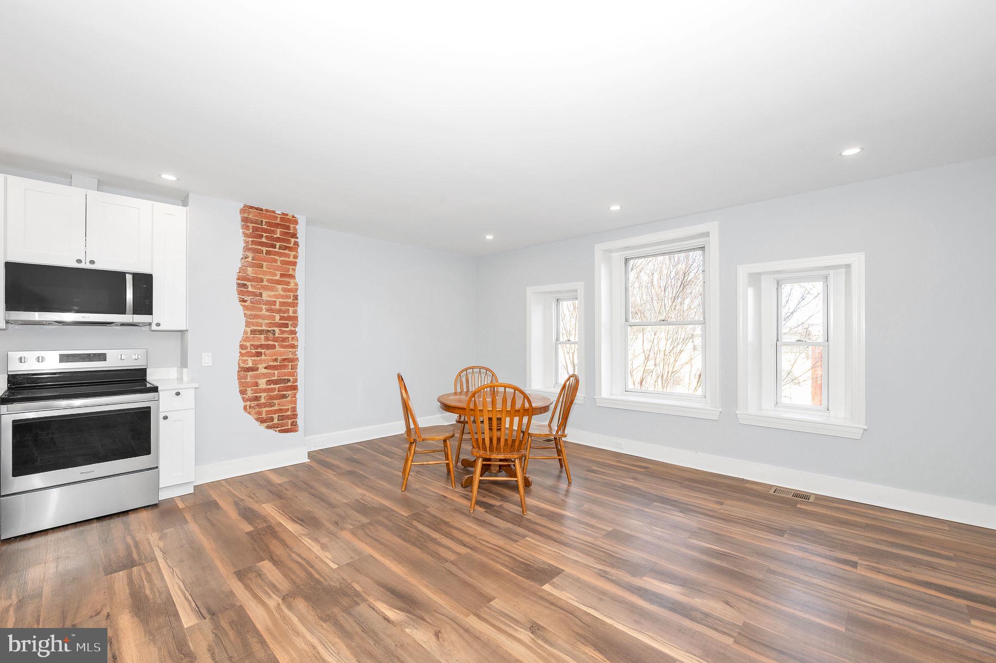 230 South Market Street, Unit 3 Frederick, MD 21701 - Photo 9 of 22 a dining room with furniture and wooden floor