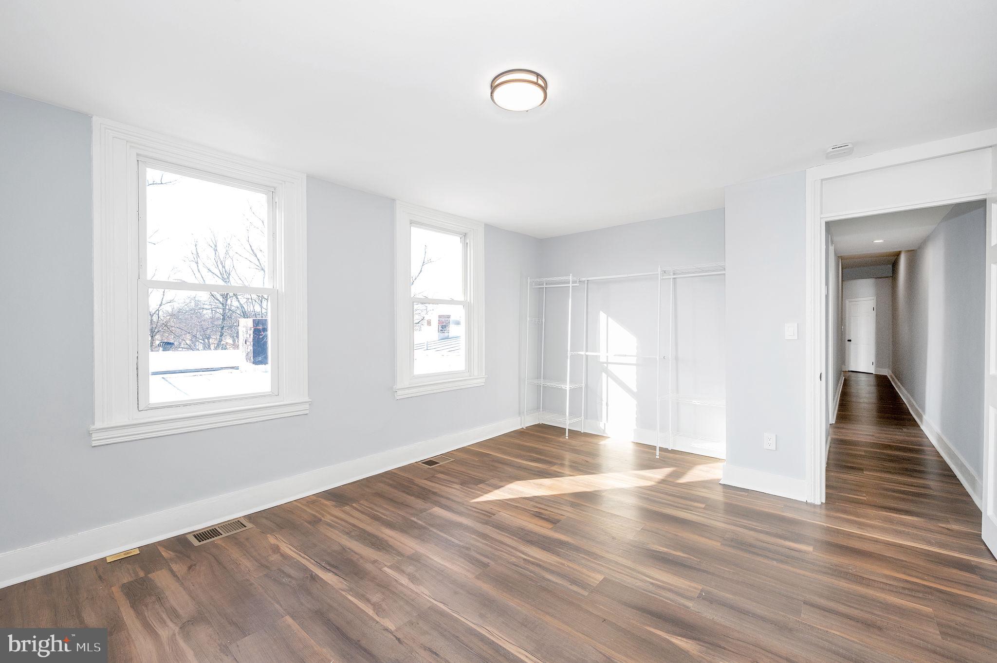 230 South Market Street, Unit 3 Frederick, MD 21701 - Photo 10 of 22 an empty room with wooden floor and windows
