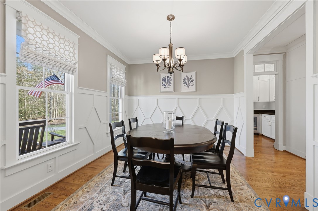 7201 Amarone Way New Kent, VA 23124 - Photo 9 of 46 a view of a dining room with furniture wooden floor and chandelier