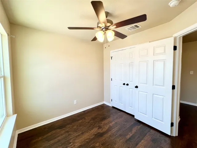 a view of a room with wooden floor