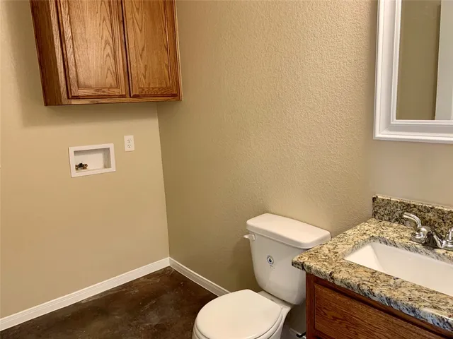 a white toilet sitting next to a bathroom sink