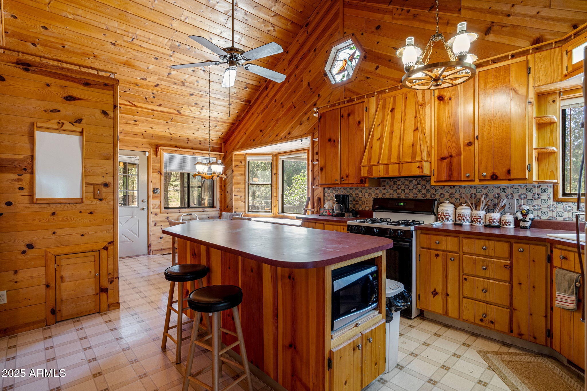 2240 Roundabout Way Overgaard, AZ 85933 - Photo 10 of 47 a kitchen with stainless steel appliances a stove a sink dishwasher and cabinets with wooden floor