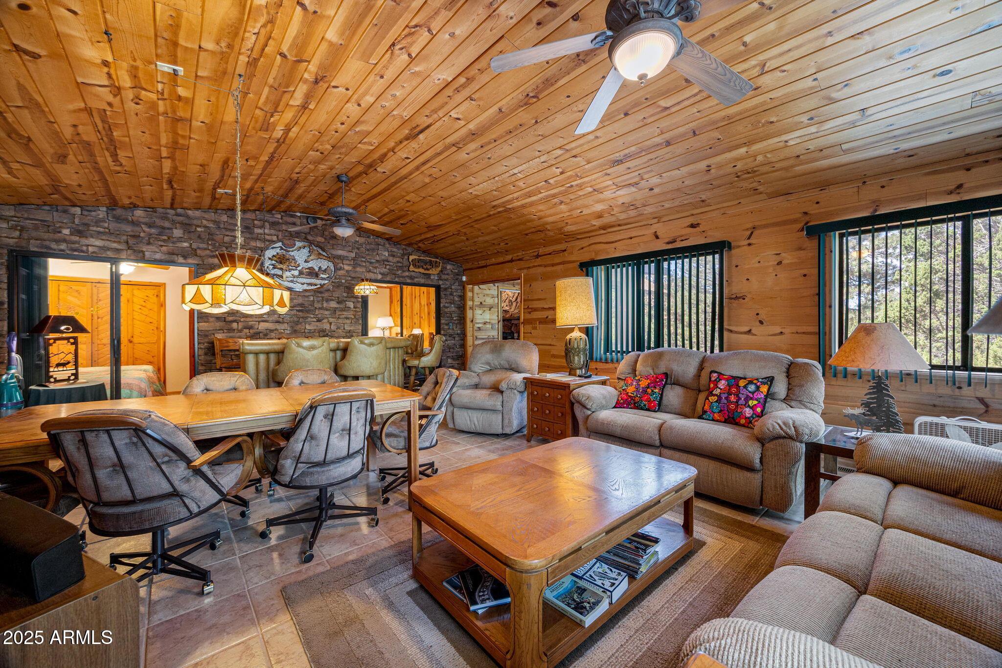 2240 Roundabout Way Overgaard, AZ 85933 - Photo 15 of 47 a living room with furniture a ceiling fan and a window