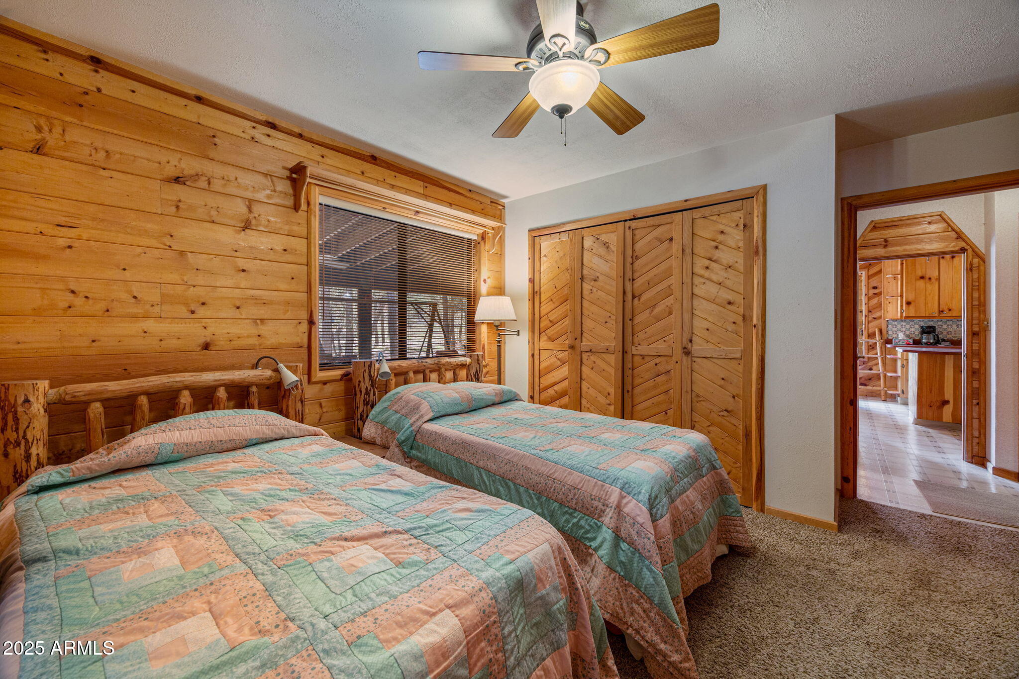 2240 Roundabout Way Overgaard, AZ 85933 - Photo 18 of 47 a bedroom with a bed and a chandelier