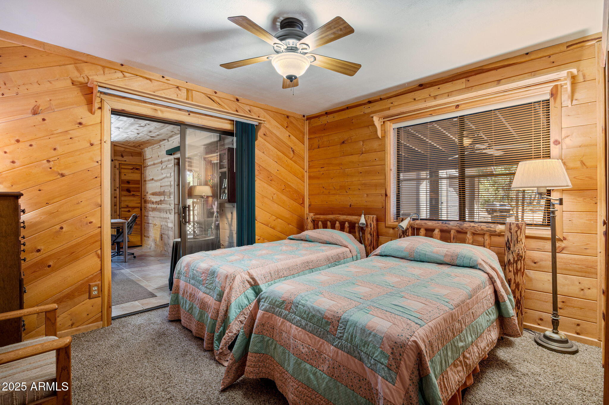 2240 Roundabout Way Overgaard, AZ 85933 - Photo 19 of 47 a bedroom with two beds and a chandelier