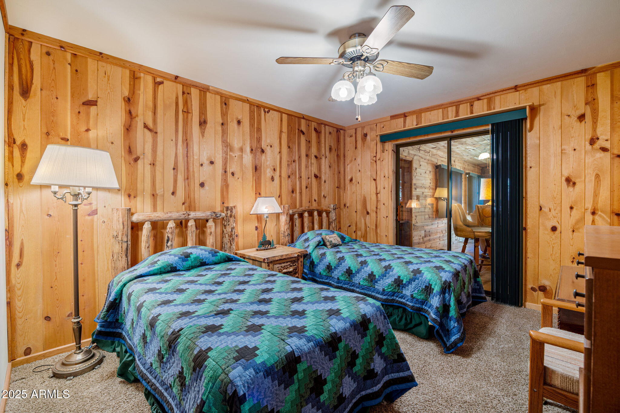 2240 Roundabout Way Overgaard, AZ 85933 - Photo 21 of 47 a bedroom with a bed and a chandelier