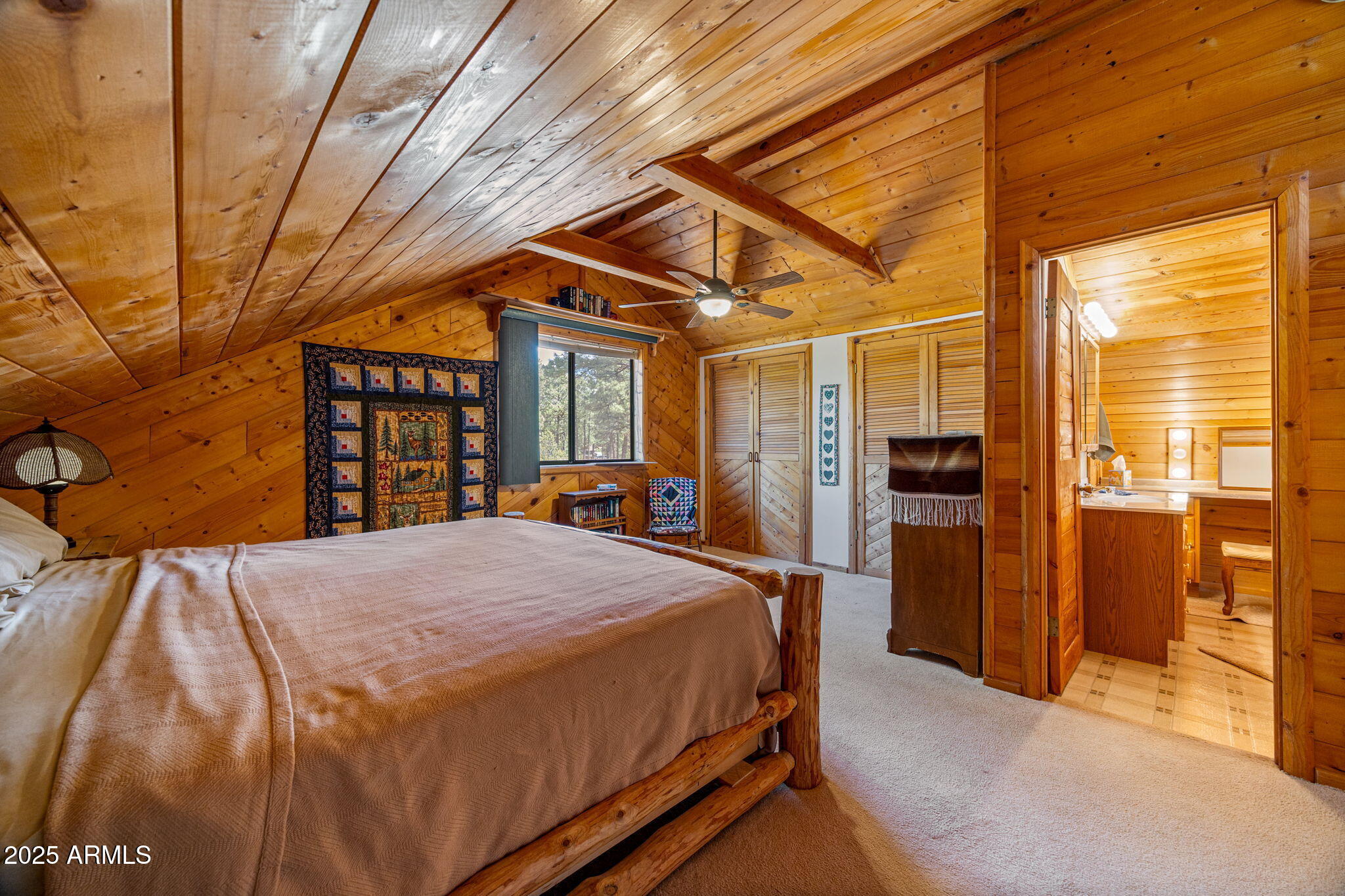 2240 Roundabout Way Overgaard, AZ 85933 - Photo 22 of 47 a bed sitting in a spacious bedroom next to a window