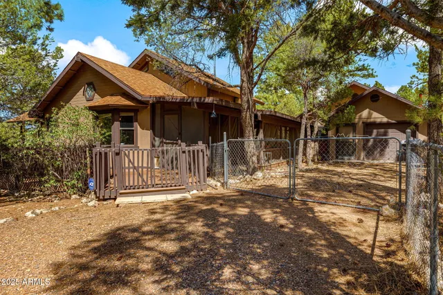 a bathroom with a granite countertop sink a toilet a mirror and shower