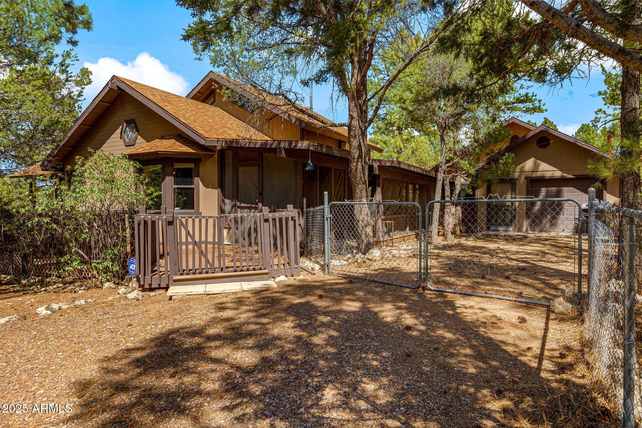 2240 Roundabout Way Overgaard, AZ 85933 - Photo 29 of 47 a view of a house with a small yard and wooden fence