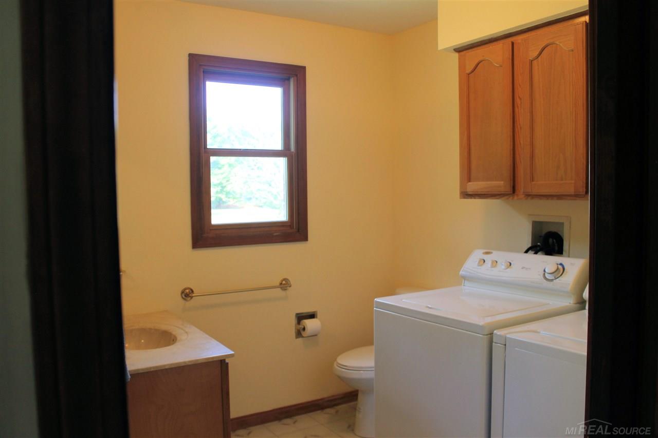 8586 Smiths Creek Road Goodells, MI 48027 - Photo 20 of 41 1st floor laundry room & 1/2 bath off the garage entrance