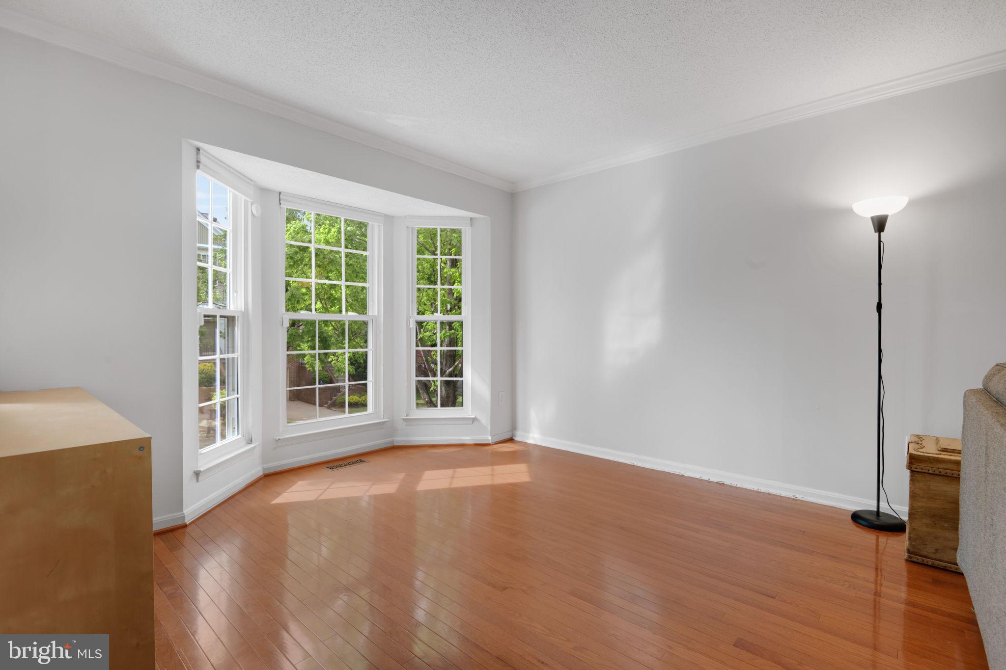 2348 Cold Meadow Way Silver Spring, MD 20906 - Photo 2 of 30 a view of an empty room with wooden floor and a window
