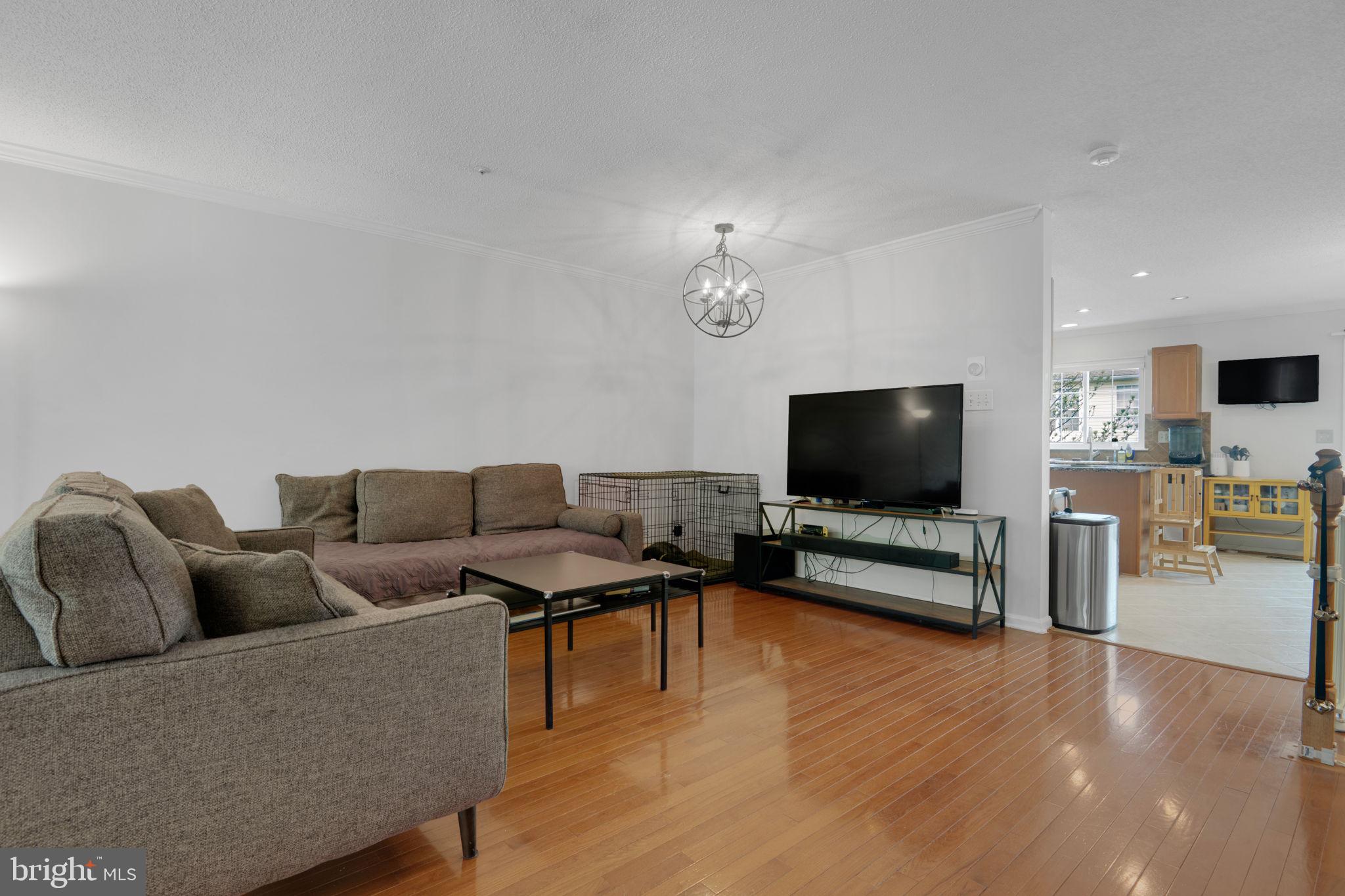 2348 Cold Meadow Way Silver Spring, MD 20906 - Photo 6 of 30 a living room with furniture and a flat screen tv