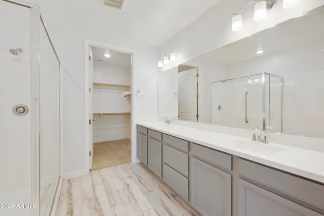 a spacious bathroom with a double vanity sink mirror and double