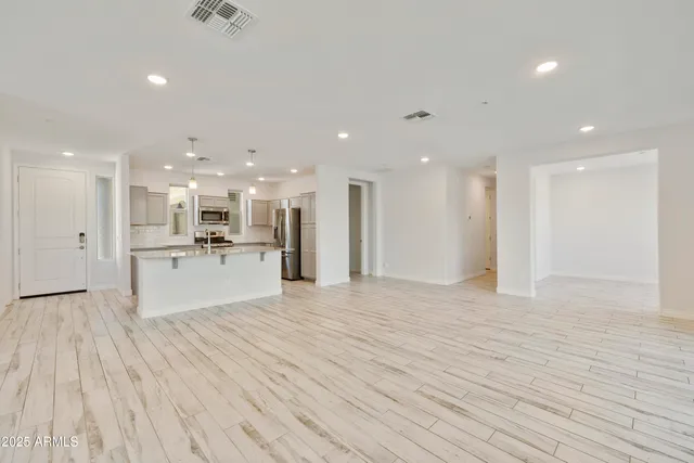 a view of kitchen with kitchen island and stainless steel appliances