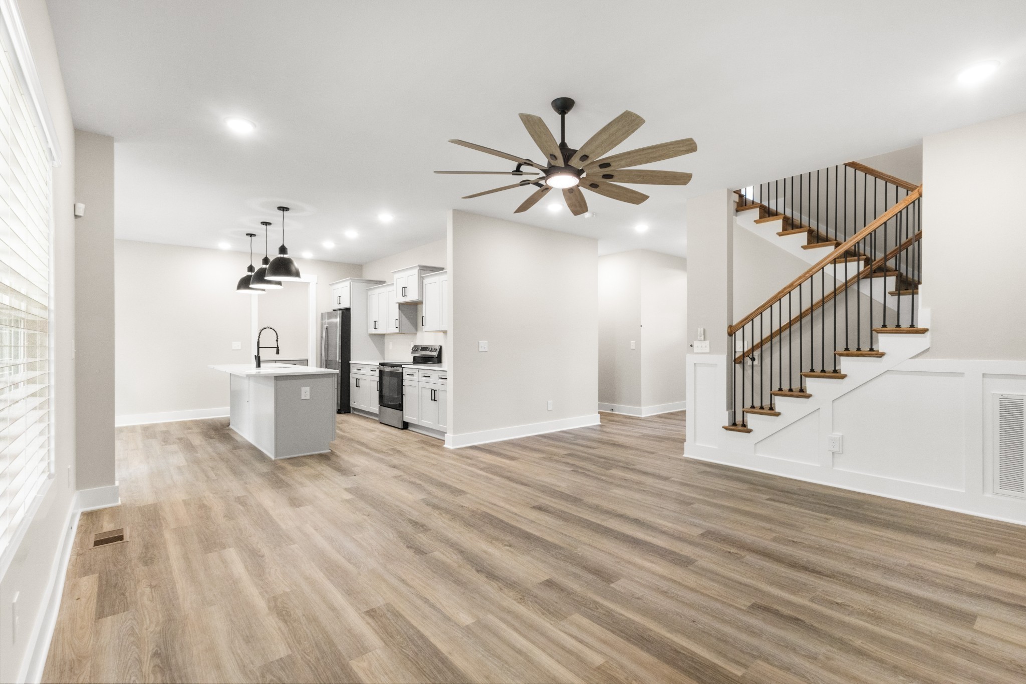 1105 Black Rock Road Clarksville, TN 37040 - Photo 29 of 45 a view of a livingroom with wooden floor and a ceiling fan