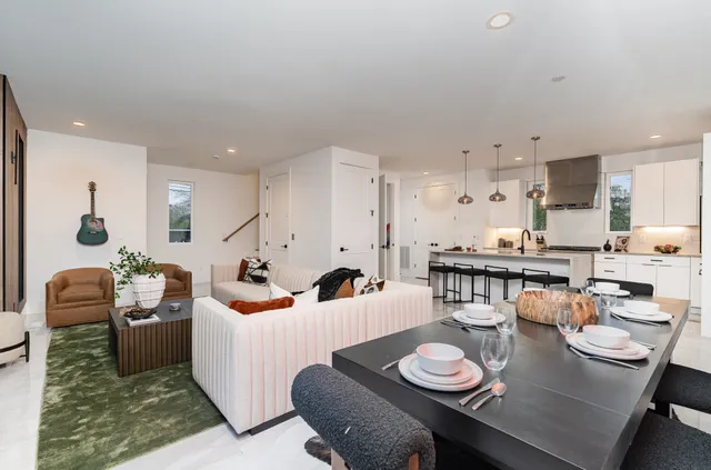 a living room with furniture and white wooden floor