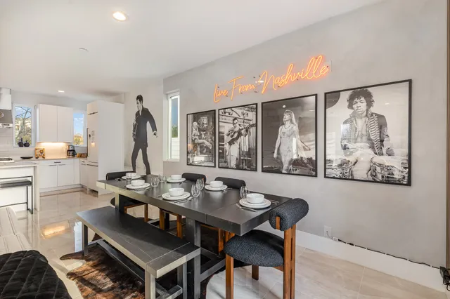 a view of a dining room with furniture a chandelier and wooden floor