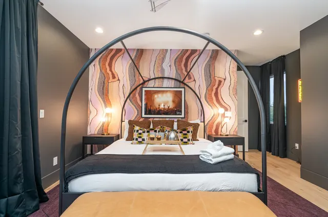 a bedroom with a bed and a mirror