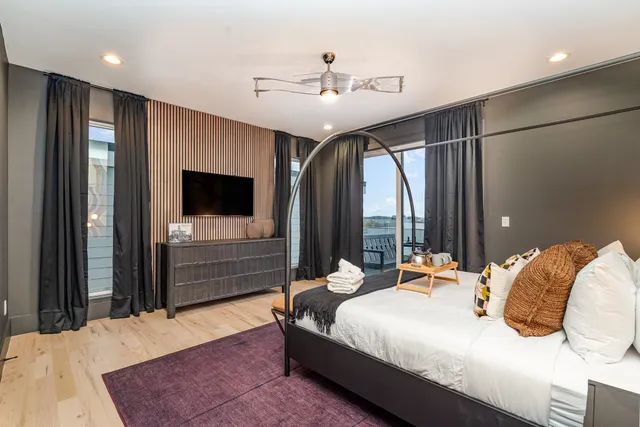 a bedroom with a bed and a flat screen tv