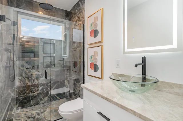 a view of a roof deck with table and chairs