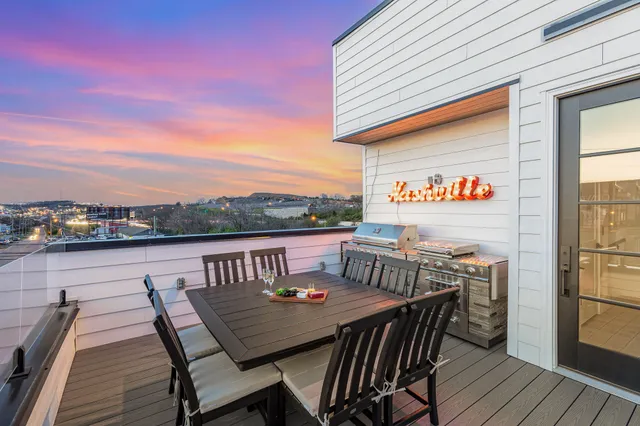 a view of a terrace with a garden and couches chairs