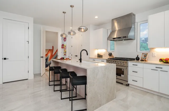 a kitchen with stainless steel appliances a sink stove and refrigerator