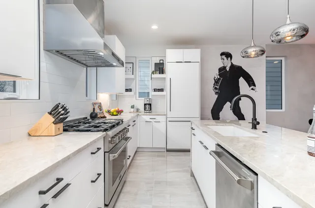 a kitchen with a sink appliances and cabinets