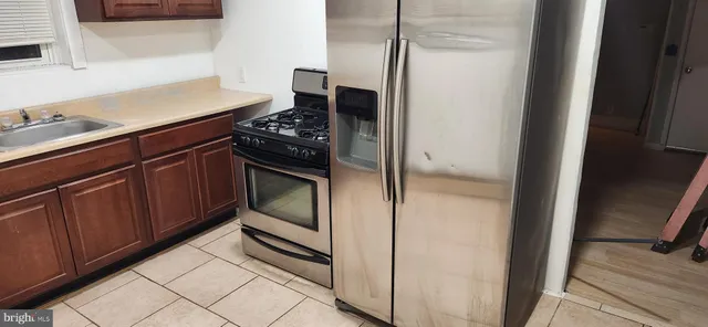 a kitchen with a refrigerator and a stove
