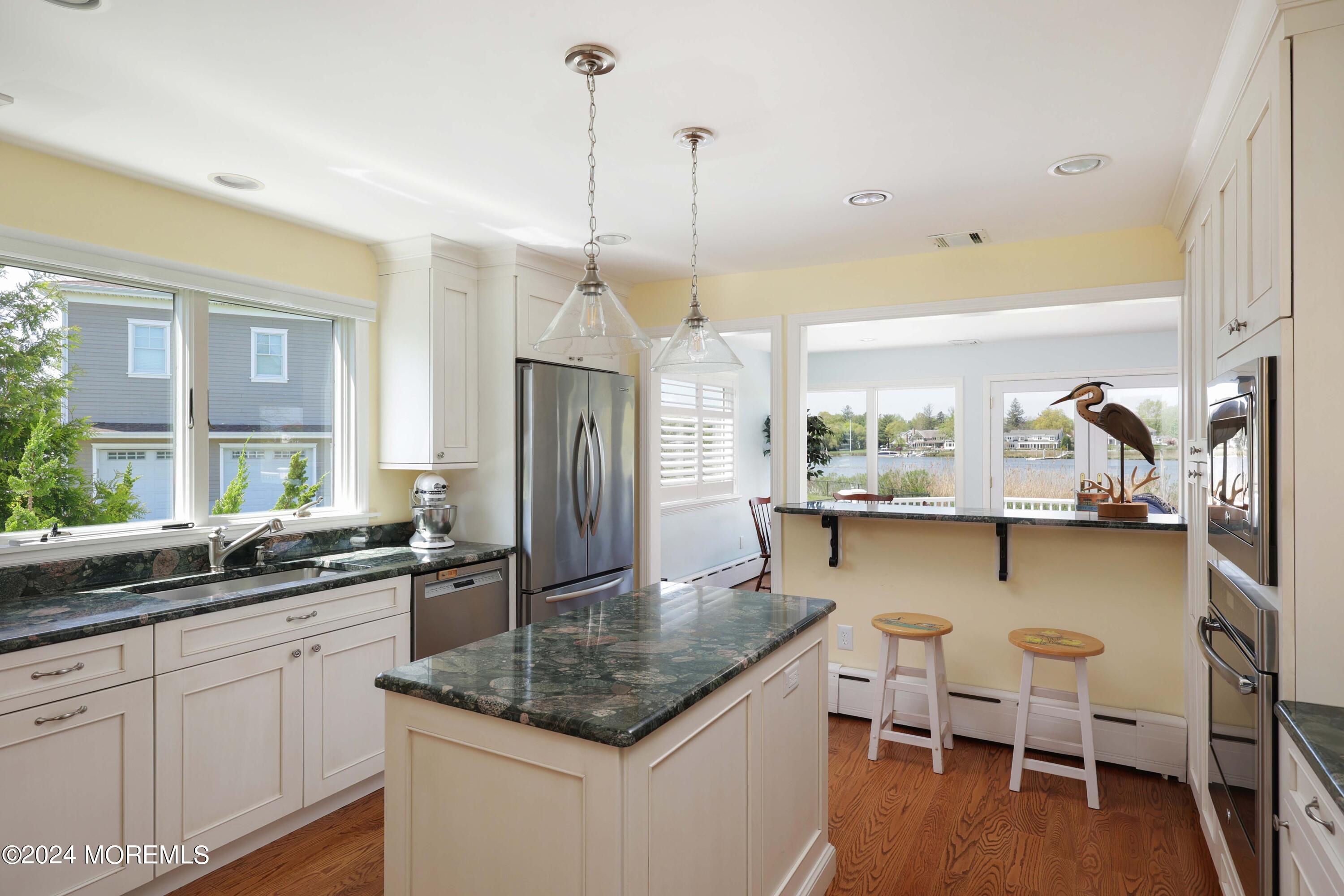 121 Horseneck Road Oceanport, NJ 07757 - Photo 11 of 48 a kitchen with stainless steel appliances granite countertop a sink a stove and a wooden floors