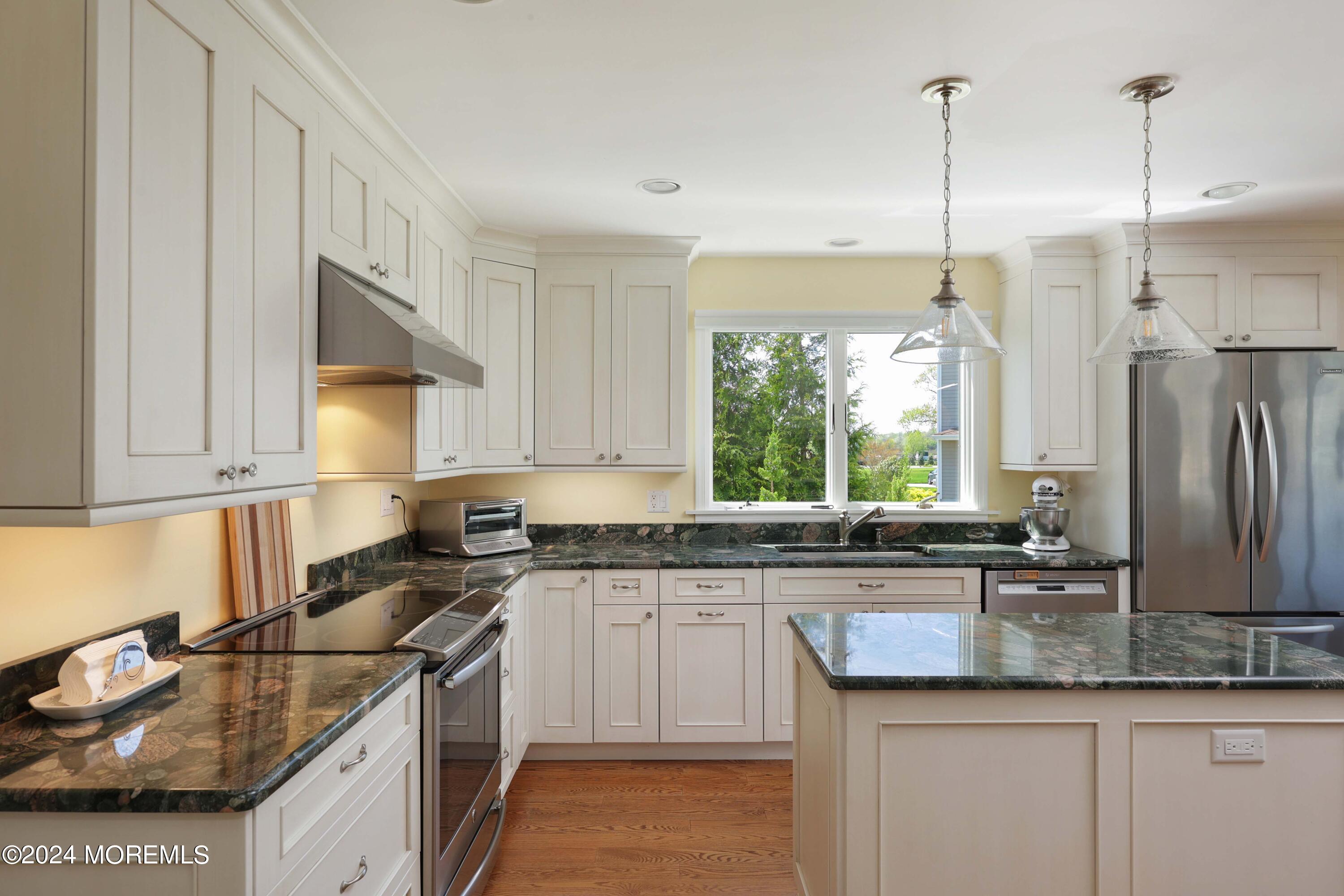 121 Horseneck Road Oceanport, NJ 07757 - Photo 12 of 48 a kitchen with granite countertop a sink a counter top space appliances and cabinets