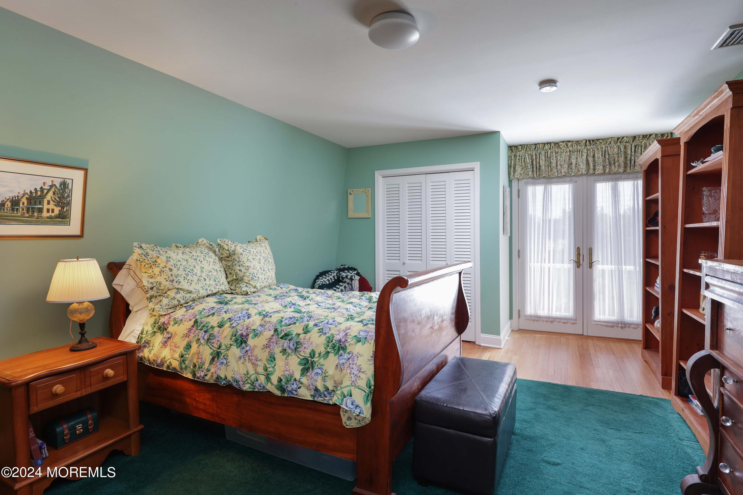 121 Horseneck Road Oceanport, NJ 07757 - Photo 21 of 48 a bedroom with a bed and wooden floor