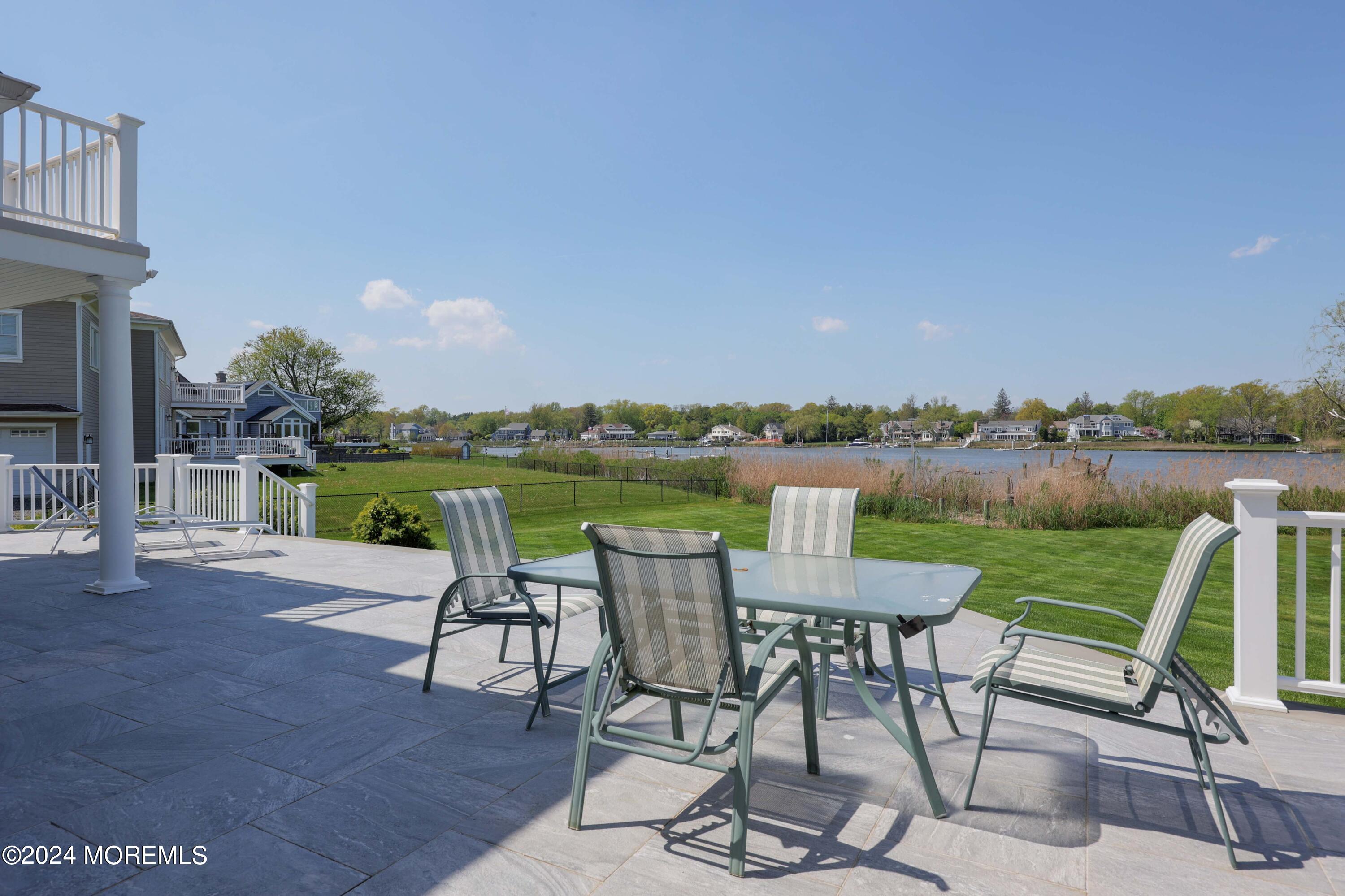 121 Horseneck Road Oceanport, NJ 07757 - Photo 24 of 48 a view of a lake with table and chairs