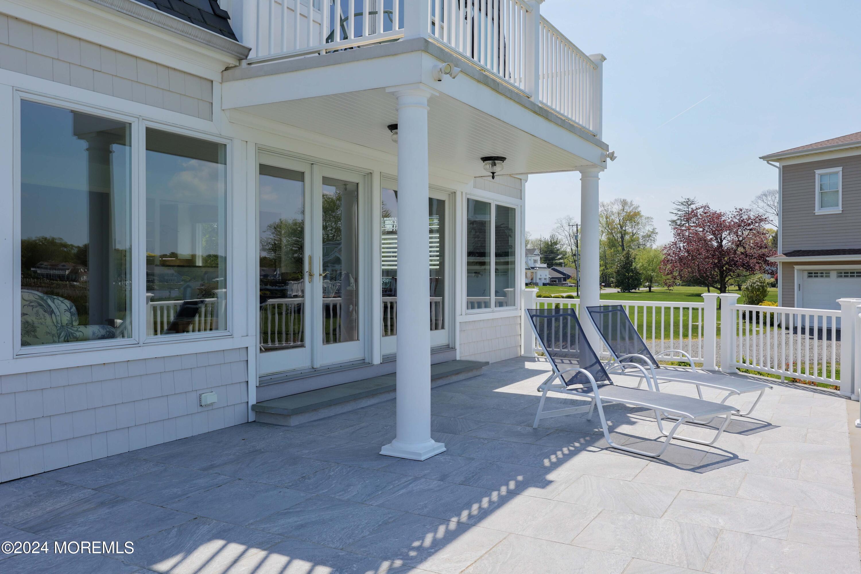 121 Horseneck Road Oceanport, NJ 07757 - Photo 31 of 48 a view of a chair and tables in patio with a fire pit