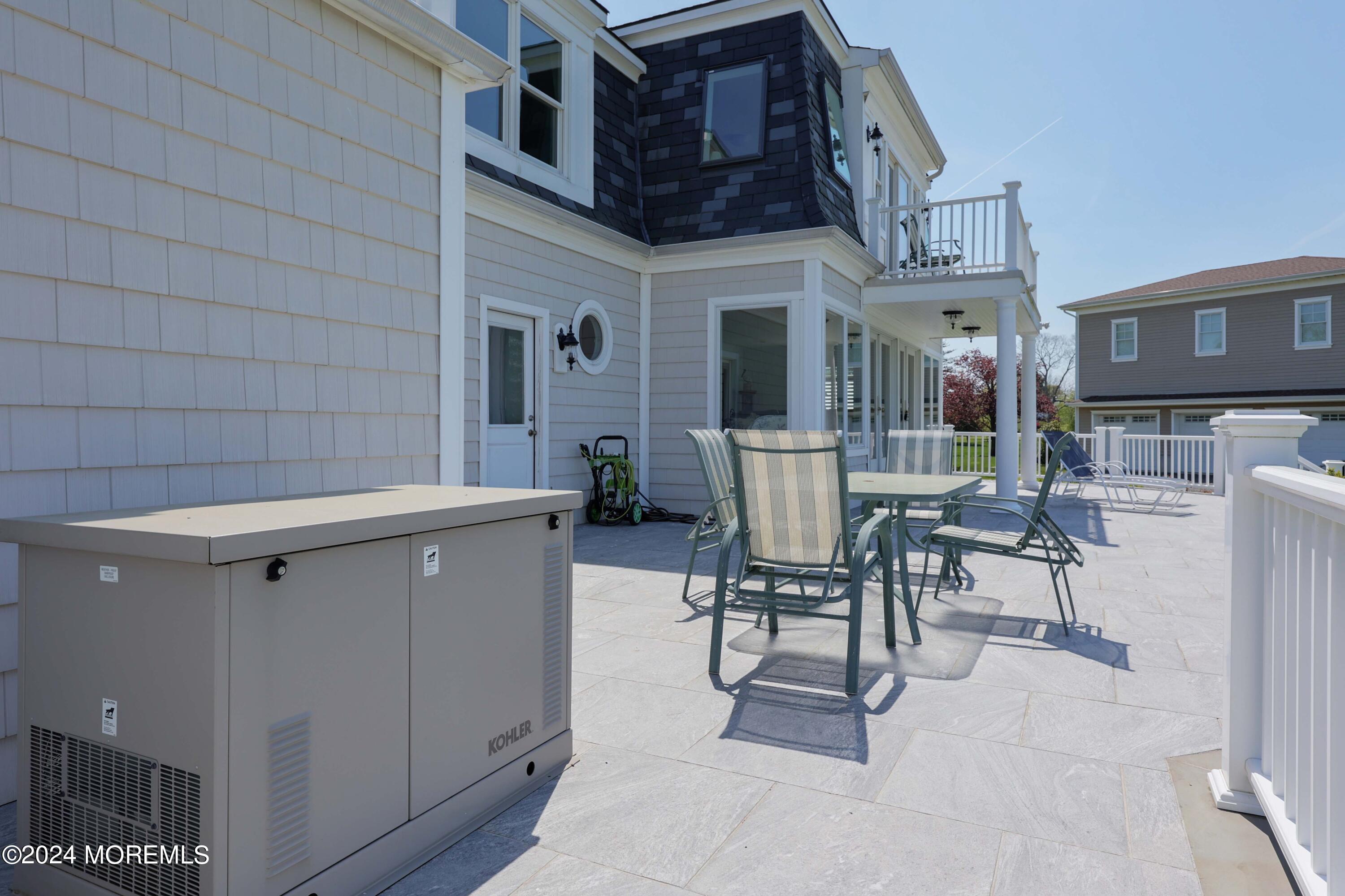 121 Horseneck Road Oceanport, NJ 07757 - Photo 32 of 48 a view of a patio with table and chairs