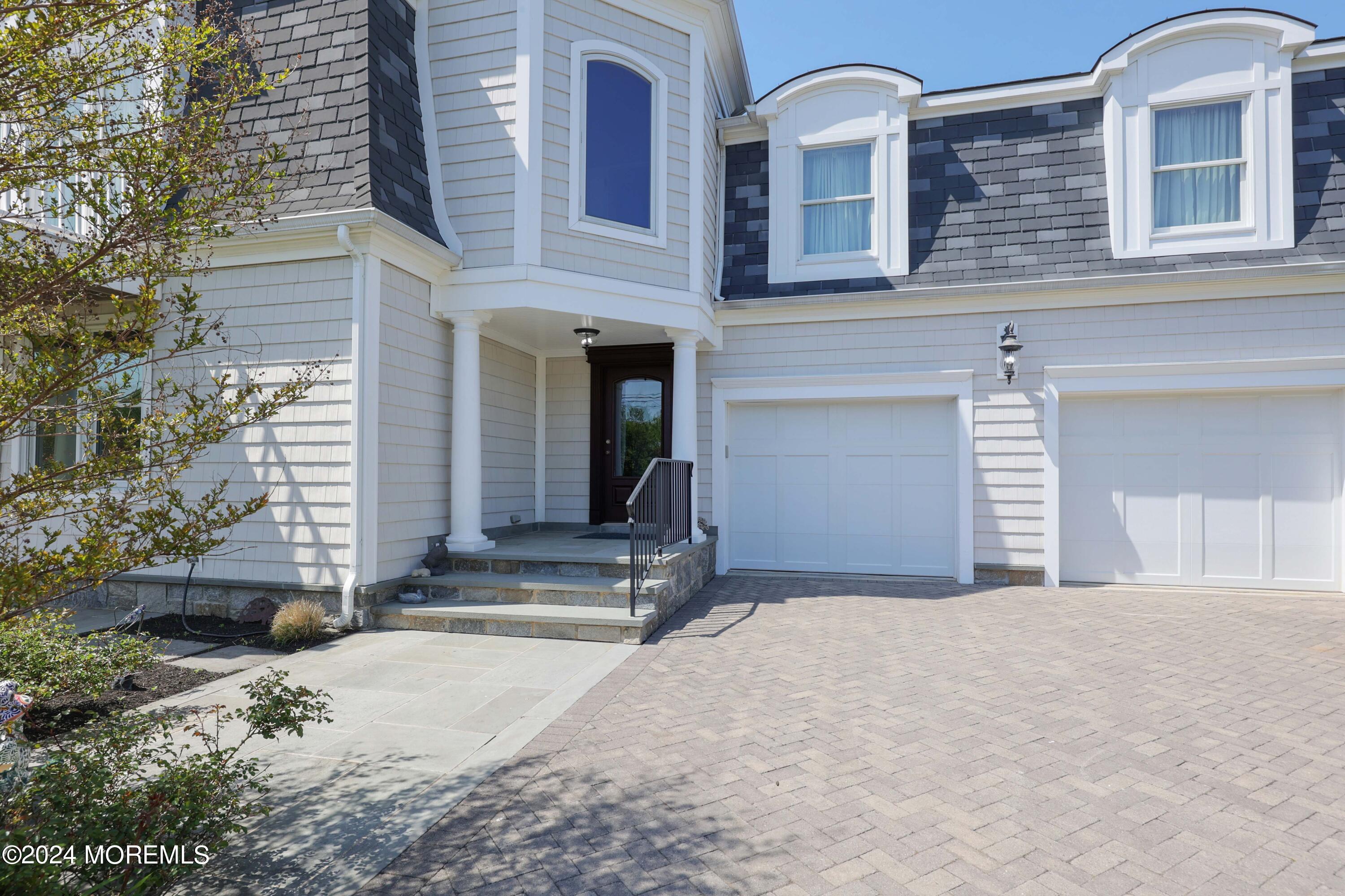 121 Horseneck Road Oceanport, NJ 07757 - Photo 4 of 48 a front view of a house with a yard and garage