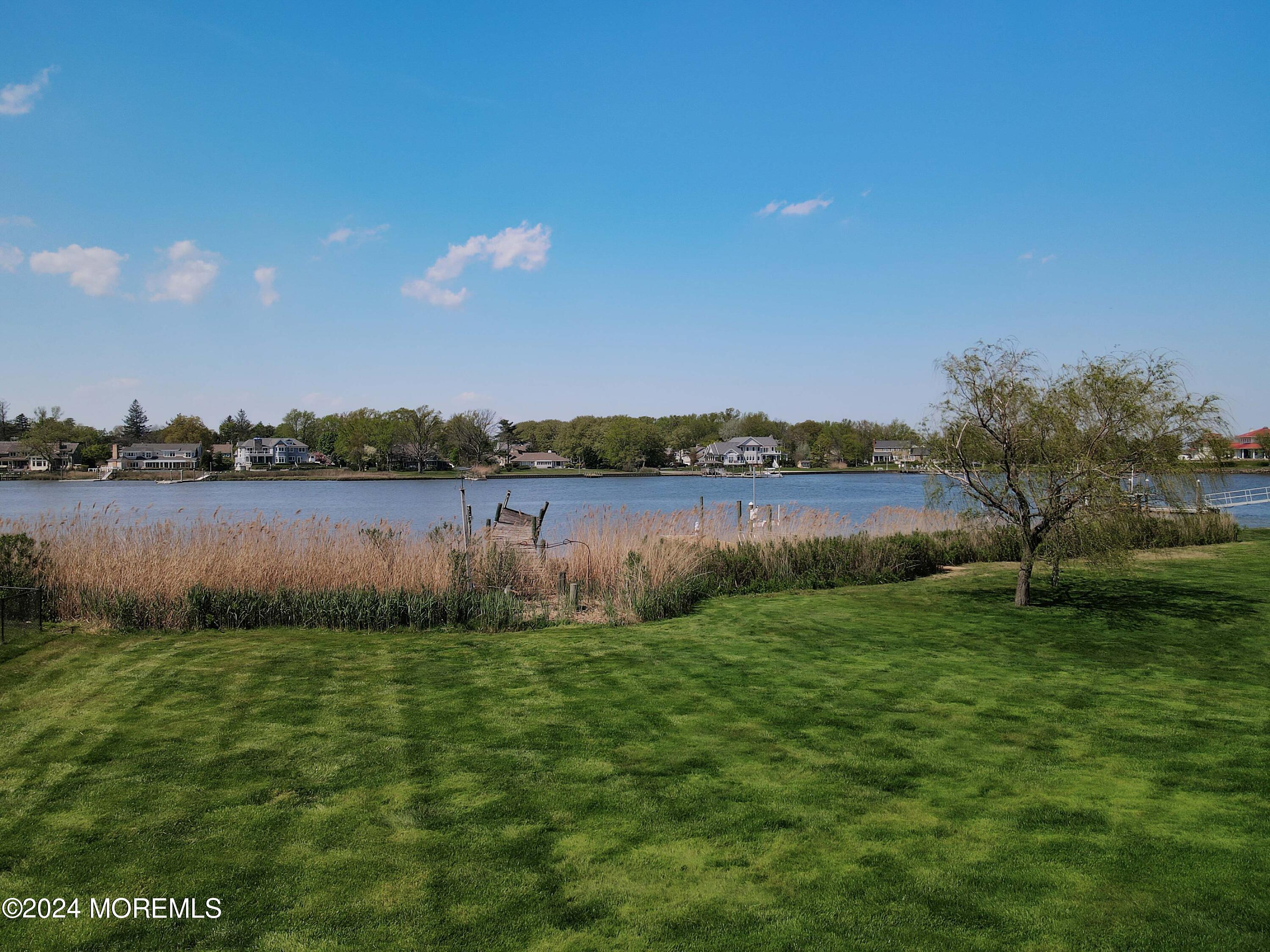 121 Horseneck Road Oceanport, NJ 07757 - Photo 47 of 48 a view of a lake with houses in the back
