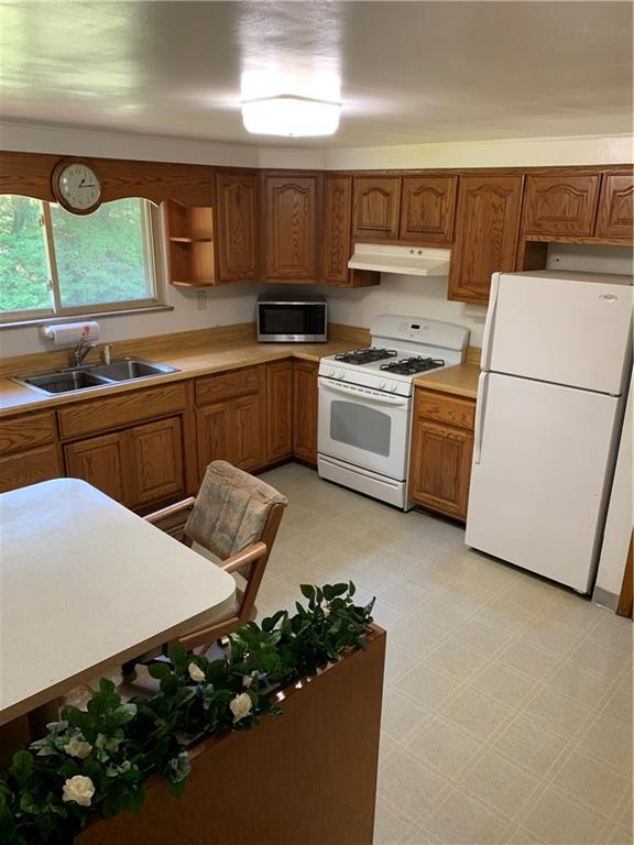 170 Crisswell Road Butler, PA 16002 - Photo 3 of 18 a kitchen with cabinets a sink and white appliances