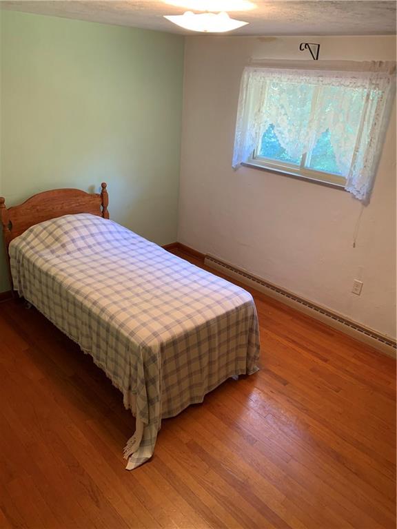 170 Crisswell Road Butler, PA 16002 - Photo 9 of 18 a bedroom with a bed wooden floor and window
