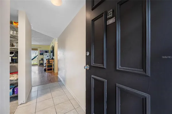 a view of a hallway with wooden floor and a living room