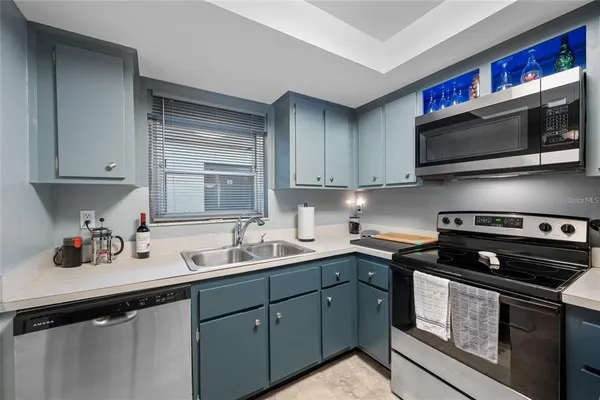 a kitchen with stainless steel appliances a sink stove and microwave