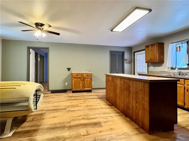 a bedroom with a bed and ceiling fan