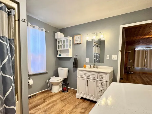 a view of washer and dryer with bathroom in the background