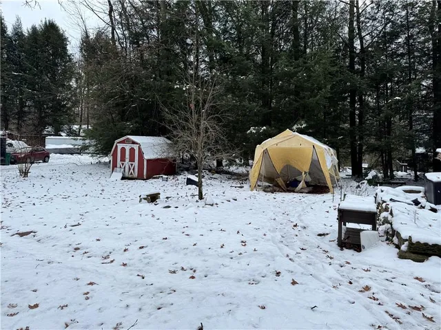 a view of a backyard with table and chairs under an umbrella