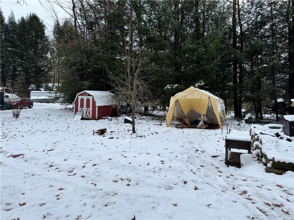 237 Mason Street Kennerdell, PA 16374 - Photo 4 of 25 a view of a backyard with table and chairs under an umbrella