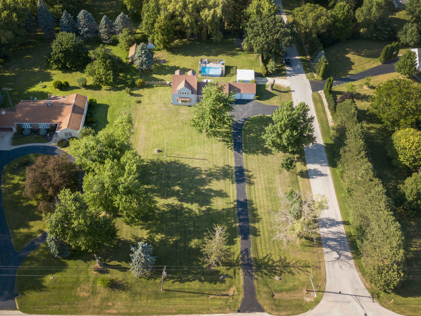20806 Lembcke Road Harvard, IL 60033 - Photo 3 of 44 an aerial view of a house with a yard lake and outdoor seating