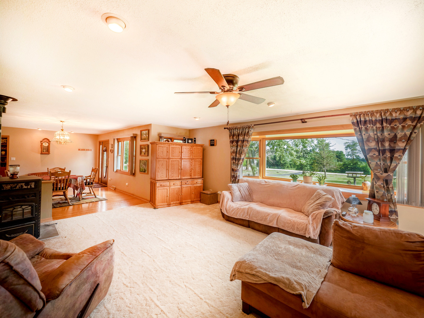 20806 Lembcke Road Harvard, IL 60033 - Photo 10 of 44 a view of a patio with couches chairs and a floor to ceiling window