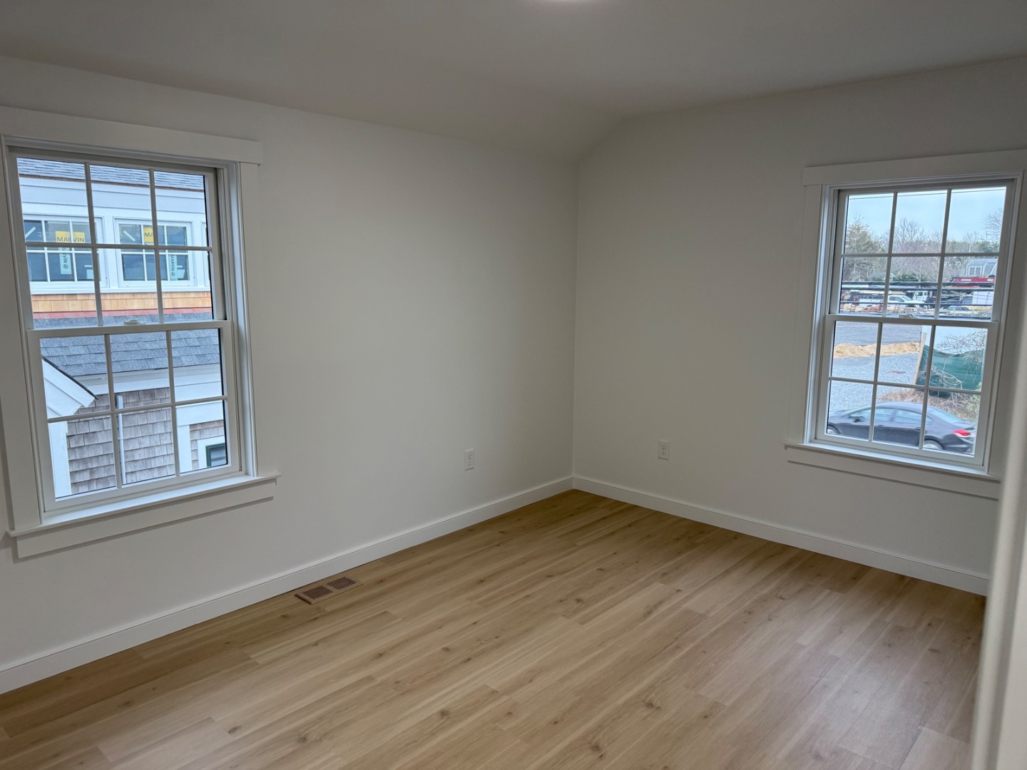 106 Old South Road, Unit A B Nantucket, MA 02554 - Photo 16 of 24 a view of an empty room with wooden floor and a window