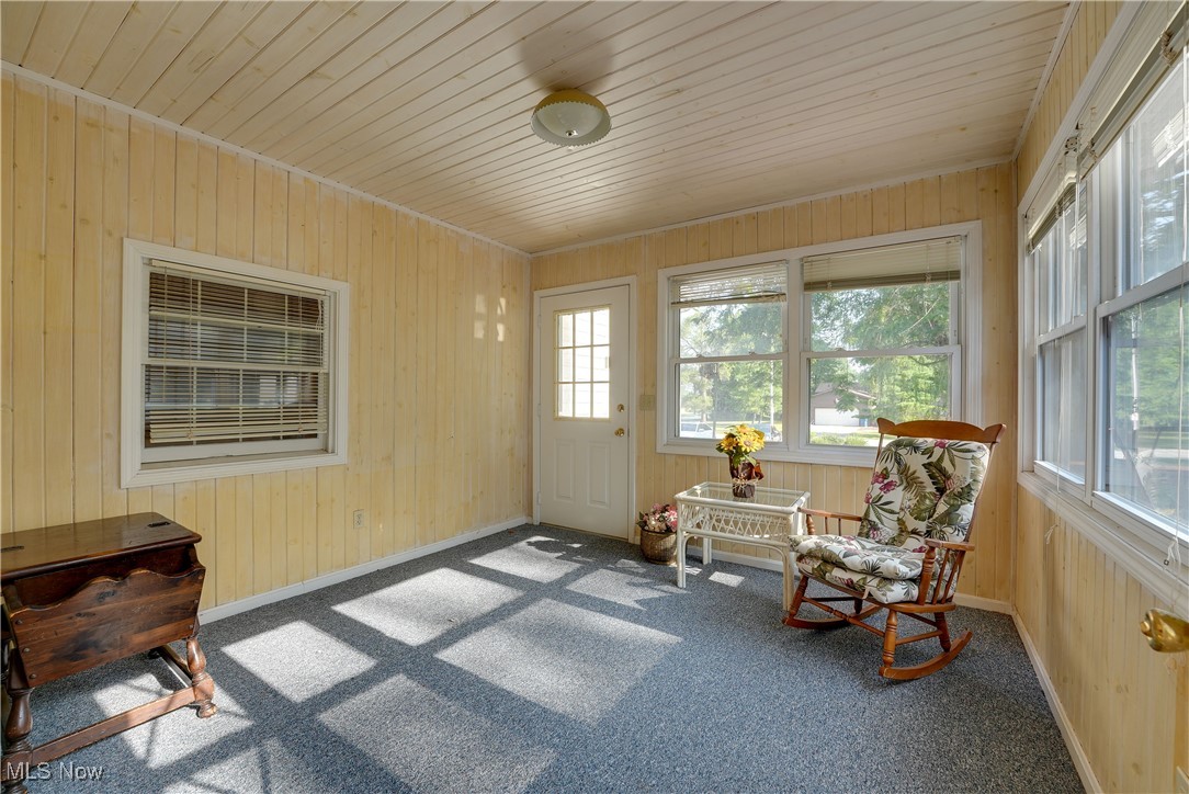 4939 Shankland Road Willoughby, OH 44094 - Photo 17 of 24 Sunroom with carpet flooring, wooden walls, and wood ceiling