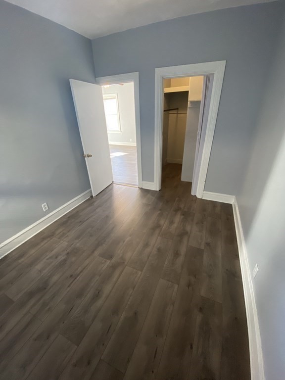 502 4th Street, Unit 2E Fall River, MA 02721 - Photo 4 of 5 an empty room with wooden floor and closet