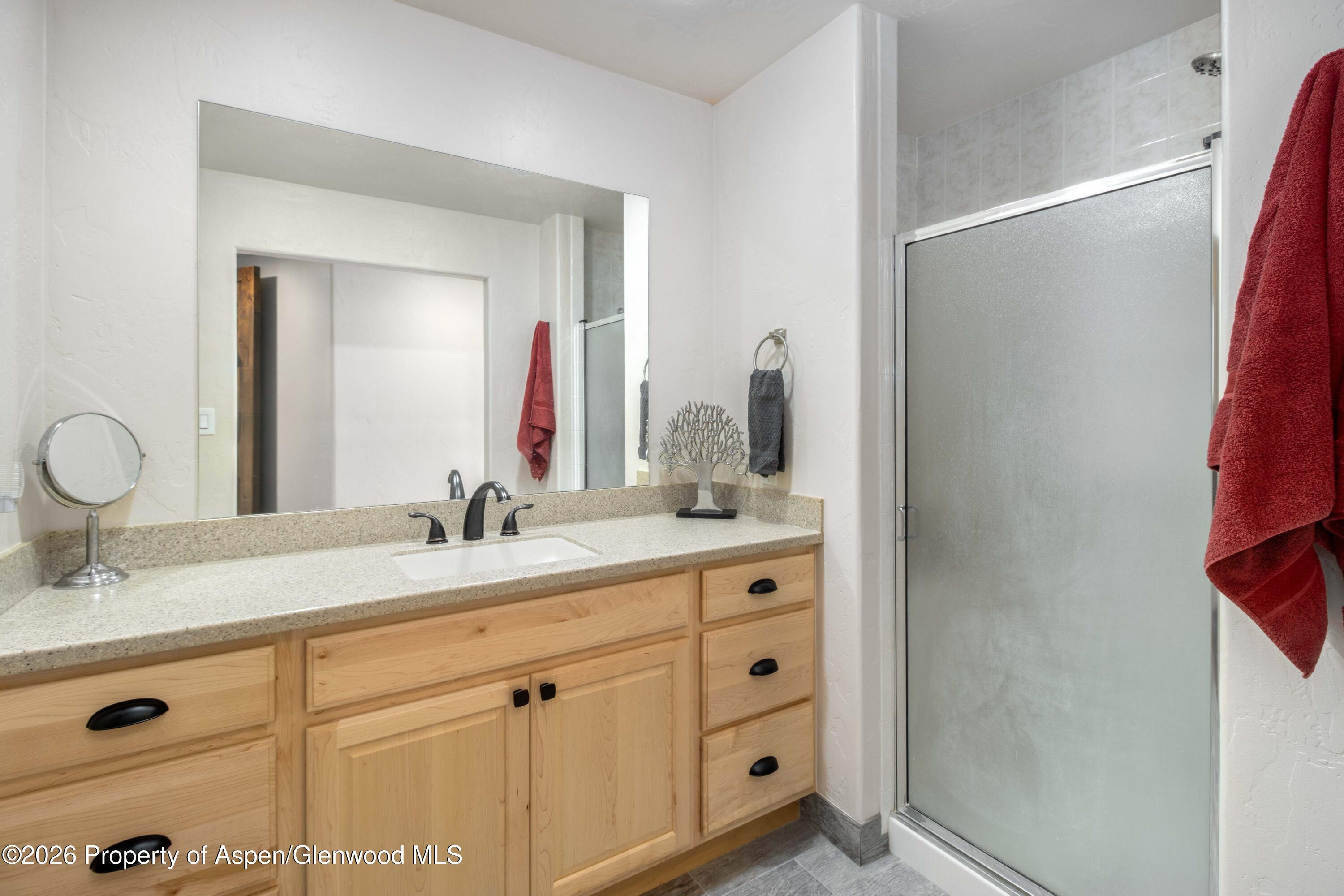 25 West Ridge Court Parachute, CO 81635 - Photo 12 of 21 a bathroom with a double vanity sink and mirror